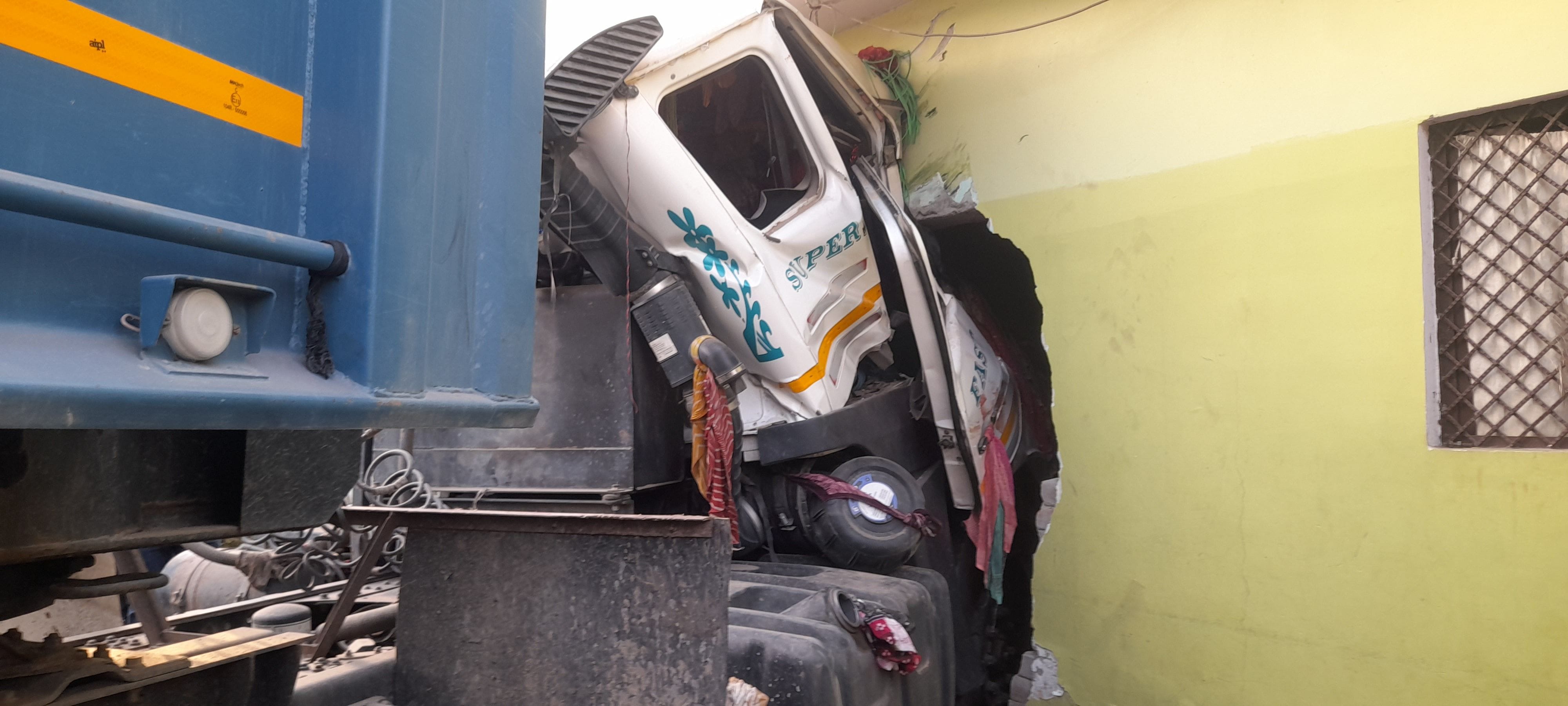 फुलवरिया बाईपास पर घर में घुसा ट्रेलर व चालक को केबिन काटकर निकालते ग्रामीण और पुलिसकर्मी।