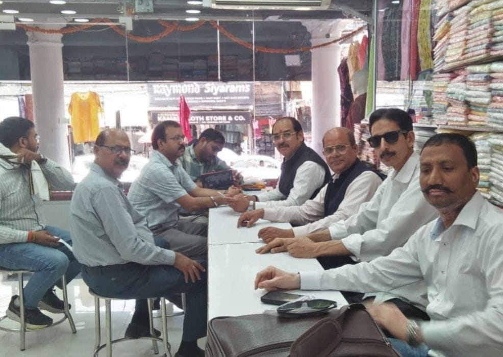 बिजली अधिकारियों के साथ बैठक करते व्यापारी।