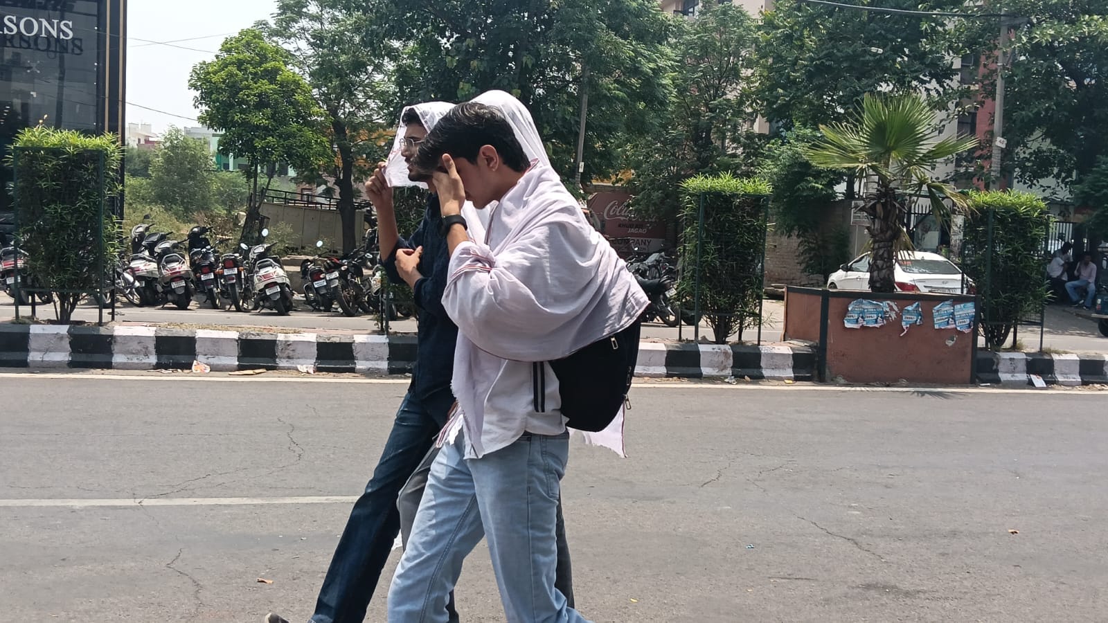 अंबाला रोड पर गर्मी से बचाव को लेकर सिर पर परना ओढ़ कर गुजरते युवक। संवाद