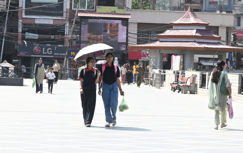 मंडी में दोपहर को तेज धूप से बचने के लिए दुपट्टा ओढ़ कर जाती युवतियां। संवाद मंडी में दोपहर को तेज धूप से बचने के लिए दुपट्टा ओढ़ कर जाती युवतियां। संवाद