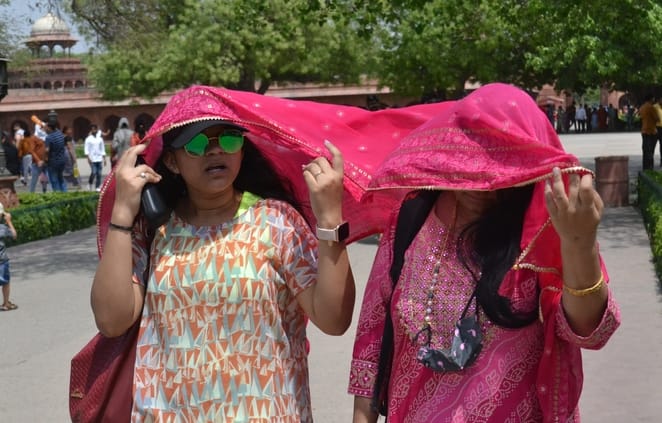 तेज धूप से बचाव करते लोग। 