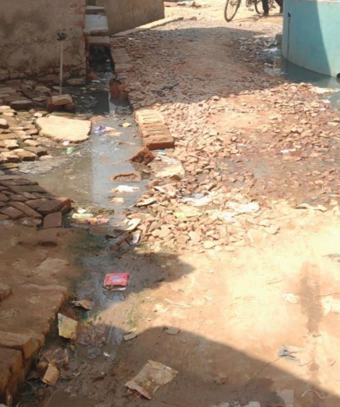 जलेसर के नगला राधे में उखड़ी पड़ी गली के बीच में ग्रामीणों डाली ईंटे। संवाद