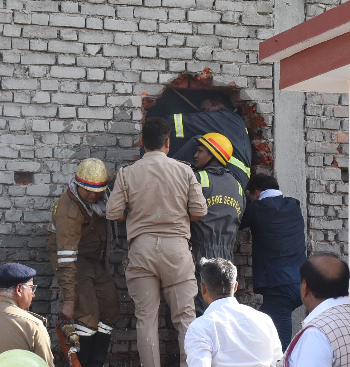 बिल्डिंग के पीछे की दीवार तोड़कर दमकल और एसडीआरएफ कर्मियों ने निकाले शव। 