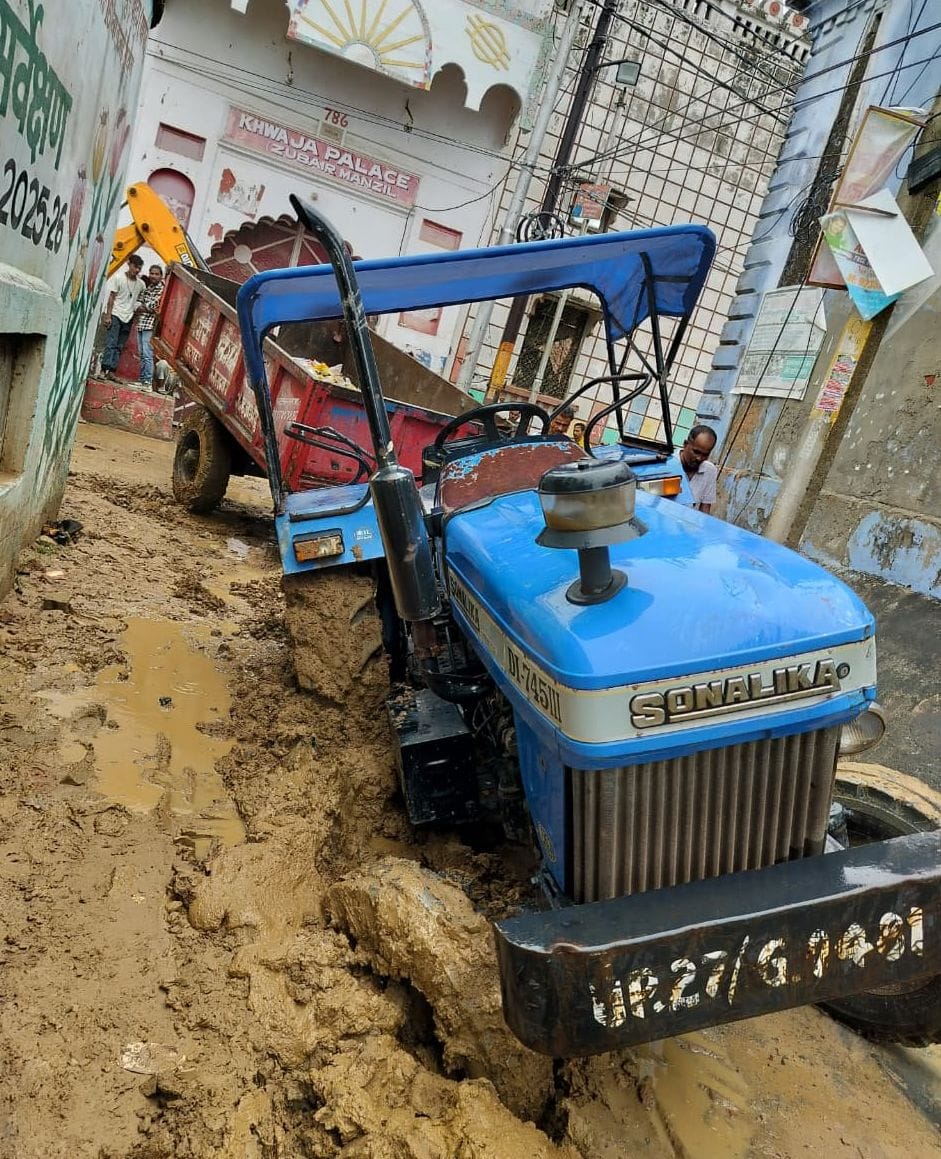 मोहल्ला बाडूजई प्रथम में पाइप डालने के लिए खोदी गई सड़क धंसने से फंसी कार। स्रोत: जागरूक पाठक