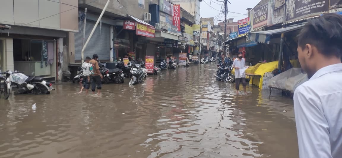आर्य चौक की तरफ से पानी से गुजरते लोग। संवाद आर्य चौक की तरफ से पानी से गुजरते लोग। संवाद