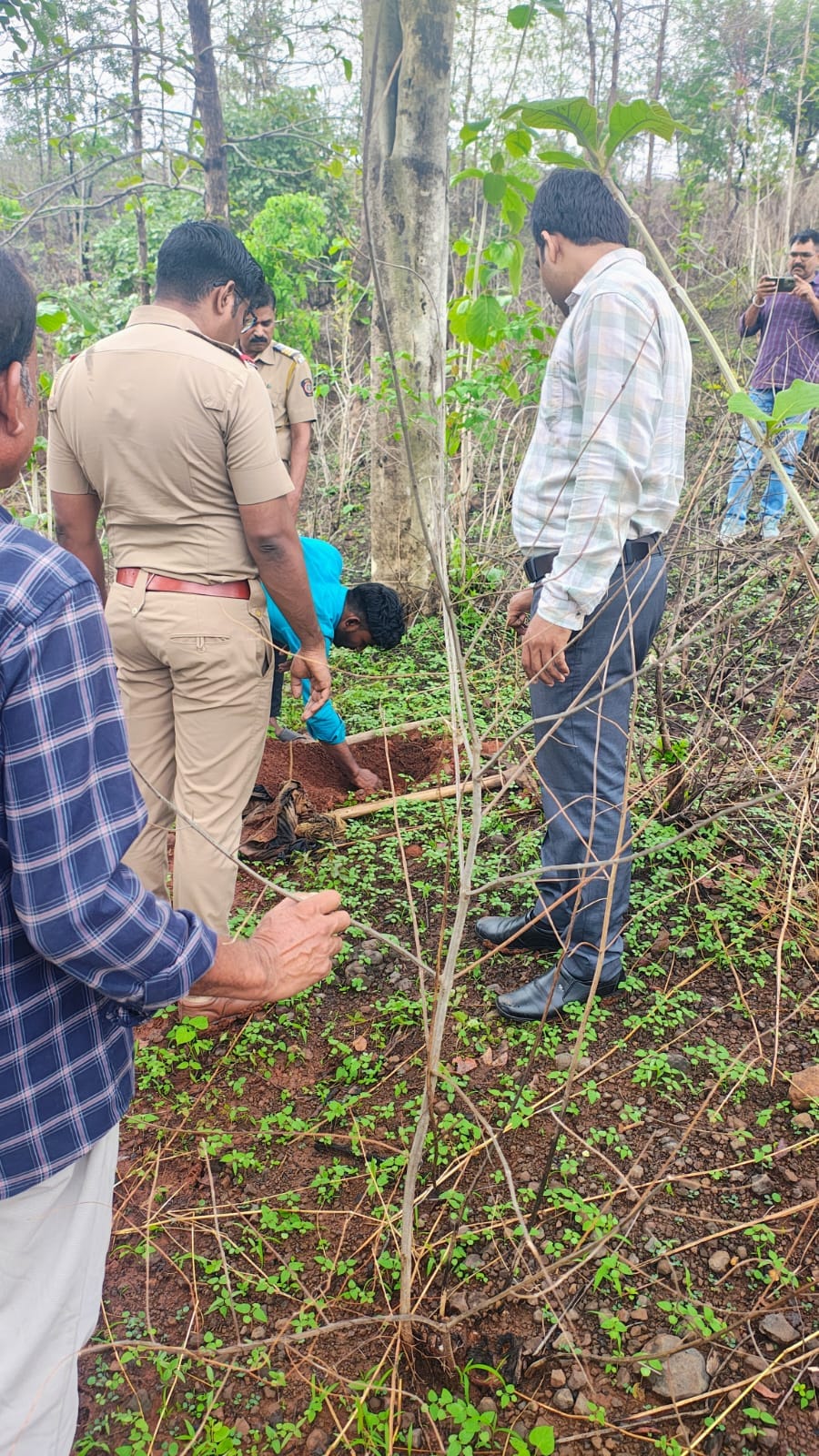 पुलिस अधिकारी जंगल में जाँच करते हुव