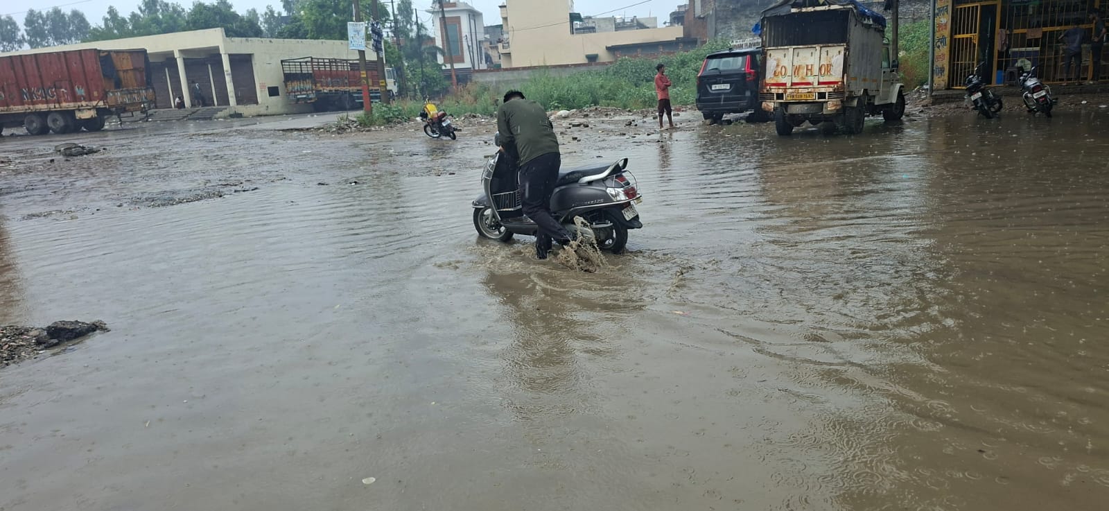 विश्वकर्मा चौक पर नाला ओवरफ्लो होने सड़क पर भरा पानी और निकलते वाहन। संवाद विश्वकर्मा चौक पर नाला ओवरफ्लो होने सड़क पर भरा पानी और निकलते वाहन। संवाद