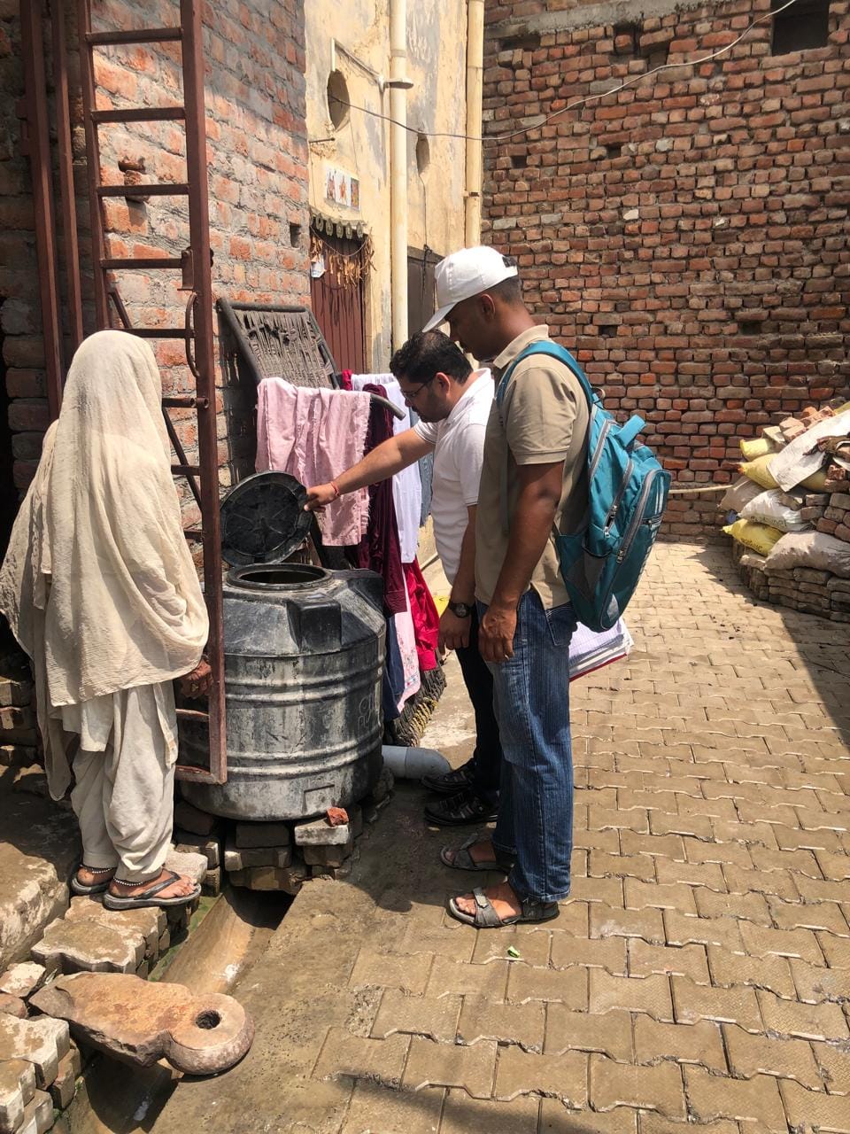 घरों में रखी टंकी व बर्तनों में डेंगू के लारवा की जांच करते स्वास्थ्य विभाग के कर्मचारी। स्वयं