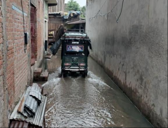 स्कूल की छुट्टी के बाद जीटी रोड से बारिश में छाता लगाकर गुजरते छात्र-छात्राएं। संवाद स्कूल की छुट्टी के बाद जीटी रोड से बारिश में छाता लगाकर गुजरते छात्र-छात्राएं। संवाद