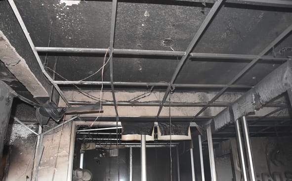 दफ्तर में लगी आग बुझाते दमकल कर्मी व जला सामान। दफ्तर में लगी आग बुझाते दमकल कर्मी व जला सामान।