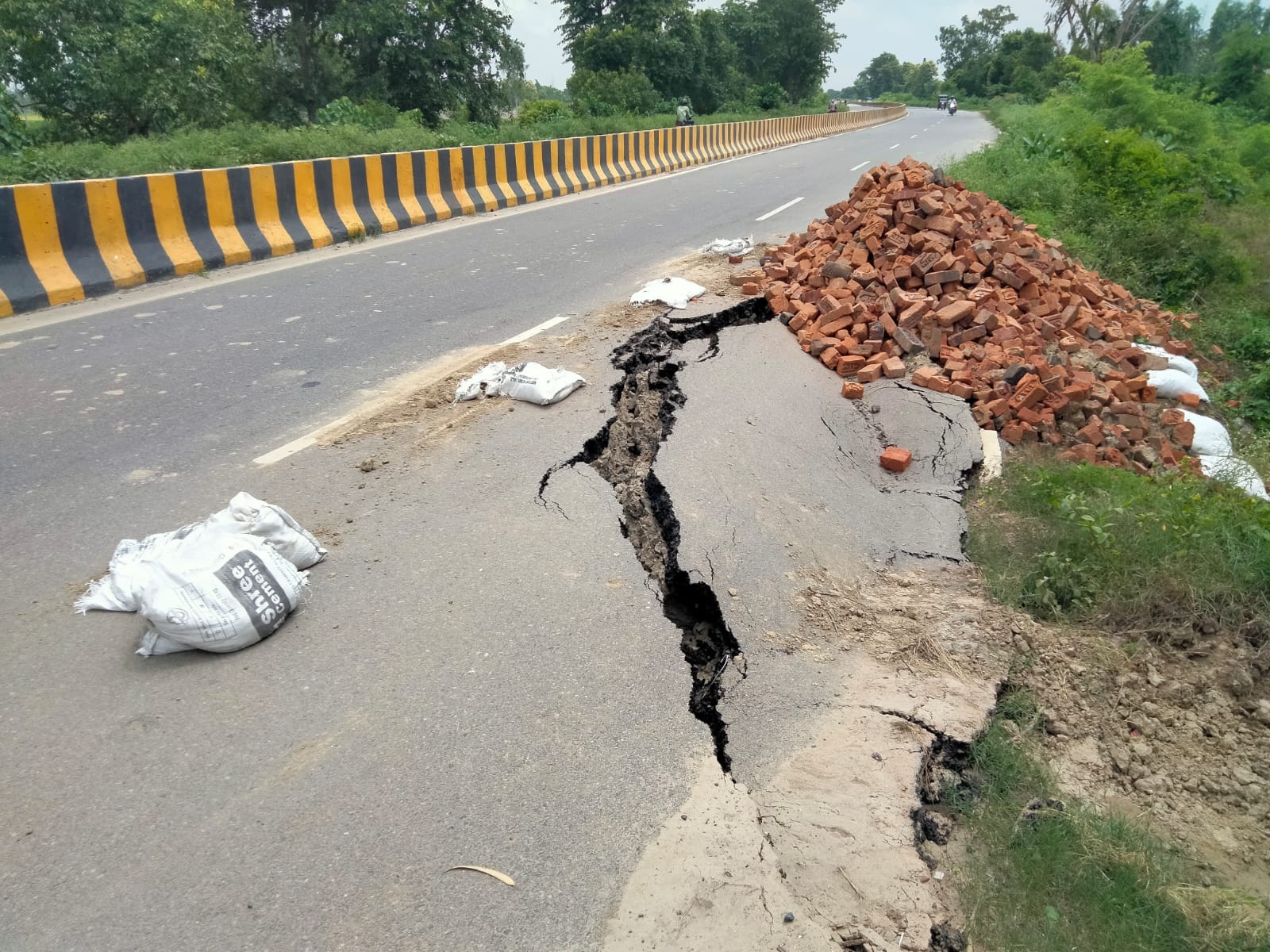सड़क किनारे बने गडढे। 