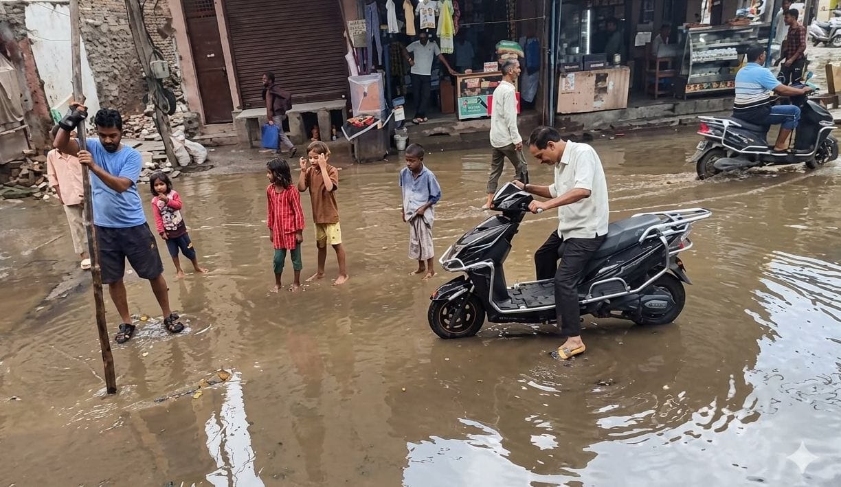 26. गड्ढे में सिस्टम...कच्चा बेरी रोड पर सीवर जाम के बाद भरा पानी। जलभराव में मैनहोल का ढक्कन ख