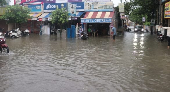 मेरठ पौड़ी हाईवे पर बिजनौर में आदर्श नगर के सामने हुए जलभराव से निकलते वाहन। संवाद मेरठ पौड़ी हाईवे पर बिजनौर में आदर्श नगर के सामने हुए जलभराव से निकलते वाहन। संवाद