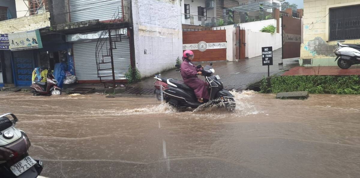 धर्मशाला में दोहपर बाद शुरू हुई बारिश से बचने के लिए सुरक्षित स्थान की ओर भागते हुए युवक। अमर धर्मशाला में दोहपर बाद शुरू हुई बारिश से बचने के लिए सुरक्षित स्थान की ओर भागते हुए युवक। अमर