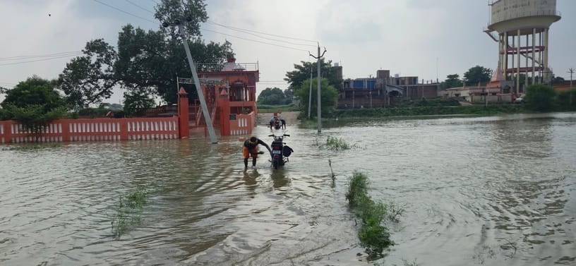 भुजाड़ी करारे गांव में बढ़ते गोमती नदी के पानी को देखते ग्रामीण। संवाद भुजाड़ी करारे गांव में बढ़ते गोमती नदी के पानी को देखते ग्रामीण। संवाद