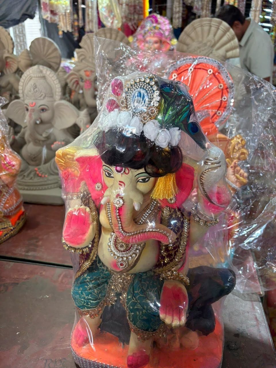 28. डीपार्क स्थित दुकान में पगड़ी- सिंदूरी रंग में बप्पा दिखाते दुकानदार। संवाद 28. डीपार्क स्थित दुकान में पगड़ी- सिंदूरी रंग में बप्पा दिखाते दुकानदार। संवाद