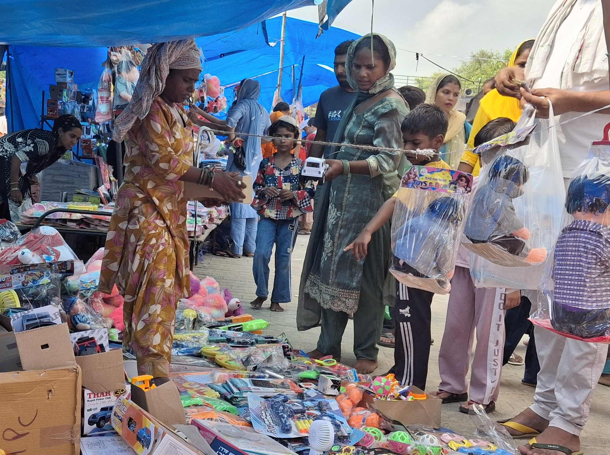 फोटो 85 : मेला परिसर में लगी खिलौनों की दुकानों पर खरीदारी करती महिलाएं और बच्चे। संवाद फोटो 85 : मेला परिसर में लगी खिलौनों की दुकानों पर खरीदारी करती महिलाएं और बच्चे। संवाद