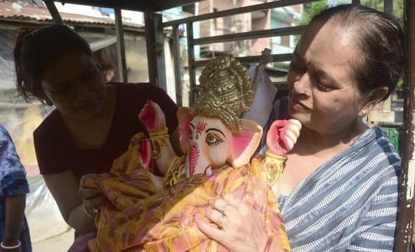 जानकारी देते गणेश प्राकट्य कमेटी के पदाधिकारी व गणपति की प्रतिमा खरीदकर घर ले जाते श्रद्धालु।