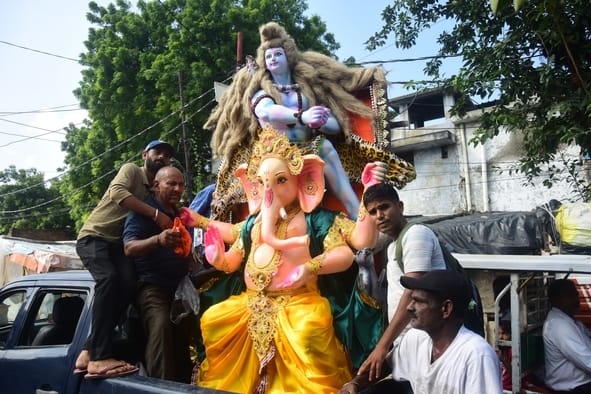 जानकारी देते गणेश प्राकट्य कमेटी के पदाधिकारी व गणपति की प्रतिमा खरीदकर घर ले जाते श्रद्धालु।