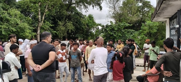 घायल अभिषेक और प्रदर्शन करते ग्रामीण।