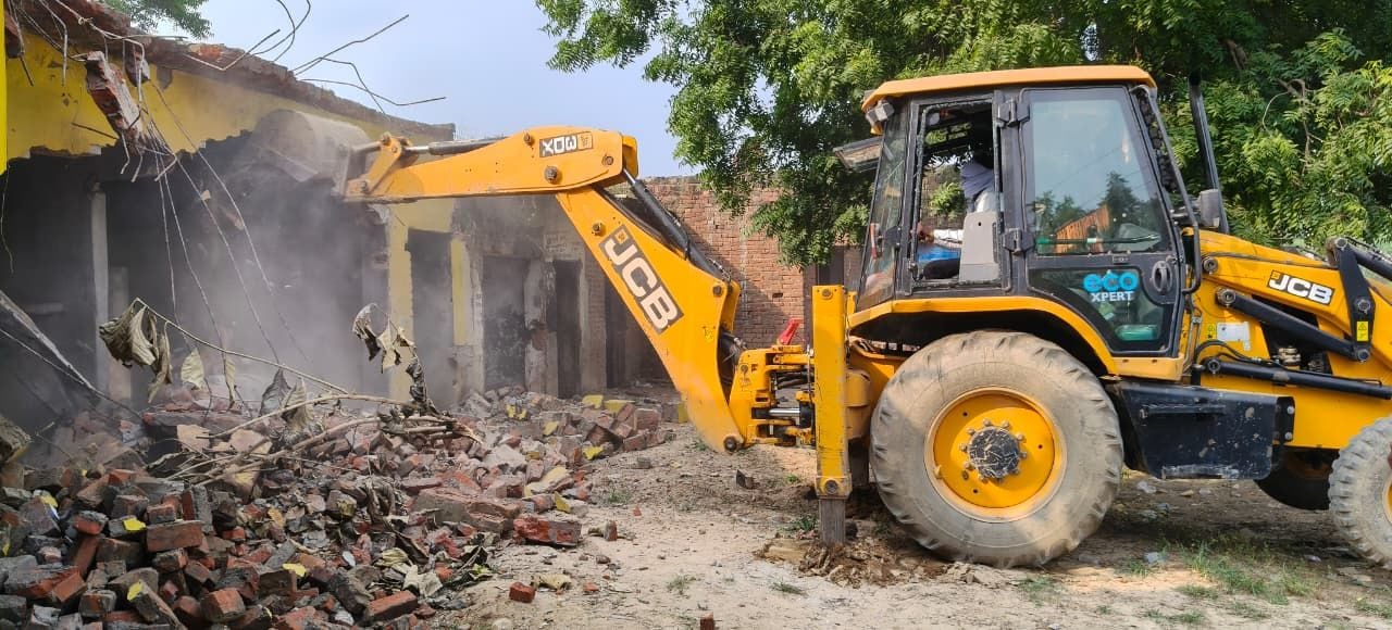 नगवा गांव में अतिक्रमण हटाता बुलडोजर, घरों के बाहर रखा सामान व मौजूद अधिकारी। - संवाद नगवा गांव में अतिक्रमण हटाता बुलडोजर, घरों के बाहर रखा सामान व मौजूद अधिकारी। - संवाद