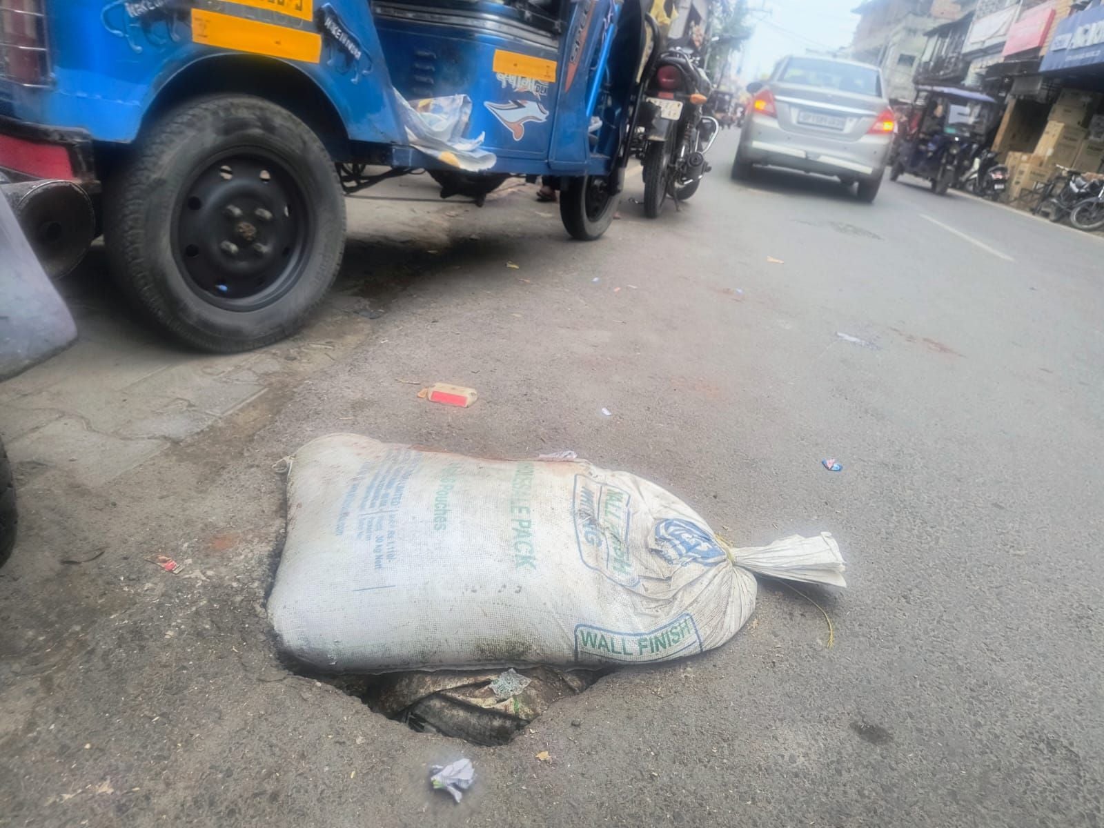 बहादुरगंज बाजार में धंसी सड़क में डाली गई रोड़ी। संवाद बहादुरगंज बाजार में धंसी सड़क में डाली गई रोड़ी। संवाद