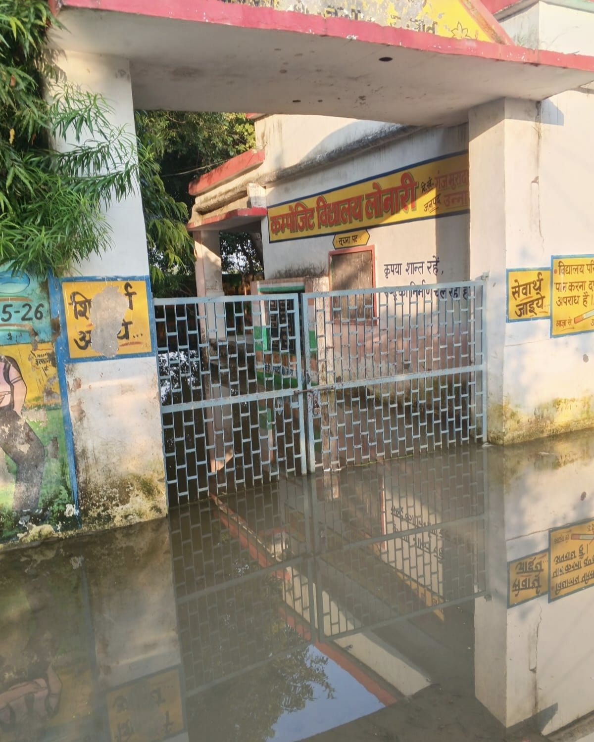 छोट्टापुरवा में रास्ते में भरे पानी से कंधे पर बच्चे को बिठाकर निकलता युवक। संवाद छोट्टापुरवा में रास्ते में भरे पानी से कंधे पर बच्चे को बिठाकर निकलता युवक। संवाद