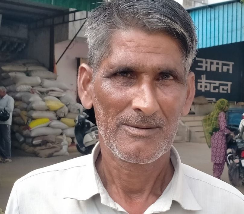 फोटो संख्या:71- अनाज मंडी में  ट्रॉली से बाजरे के बैग को उतारते  किसान--संवाद