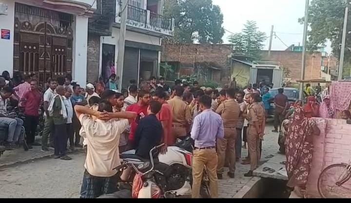 पल्हना रोड पर मृतक के घर पर लगी लोगों की भीड़, मौजूद पुलिस कर्मी। संवाद