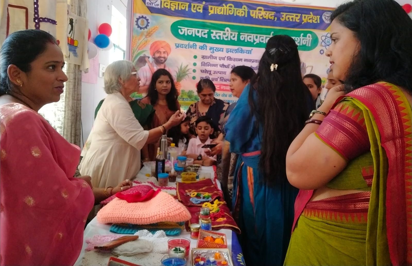 प्रदर्शनी में पेंटिंग दिखाता चित्रकार।