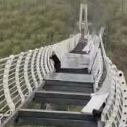 Glass bridge of Piyan mountain china broken due to strong winds man left dangling in air pic goes viral