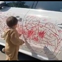 viral video kid scribbles on a white car with red lipstick